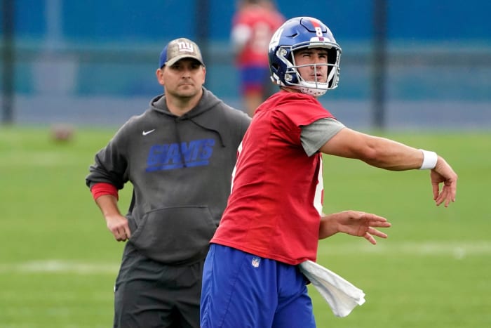 New York Giants quarterback Daniel Jones (8) throws the ball as head coach Joe Judge looks on during OTA practice at the Quest Diagnostics Training Center on Friday, June 4, 2021, in East Rutherford.